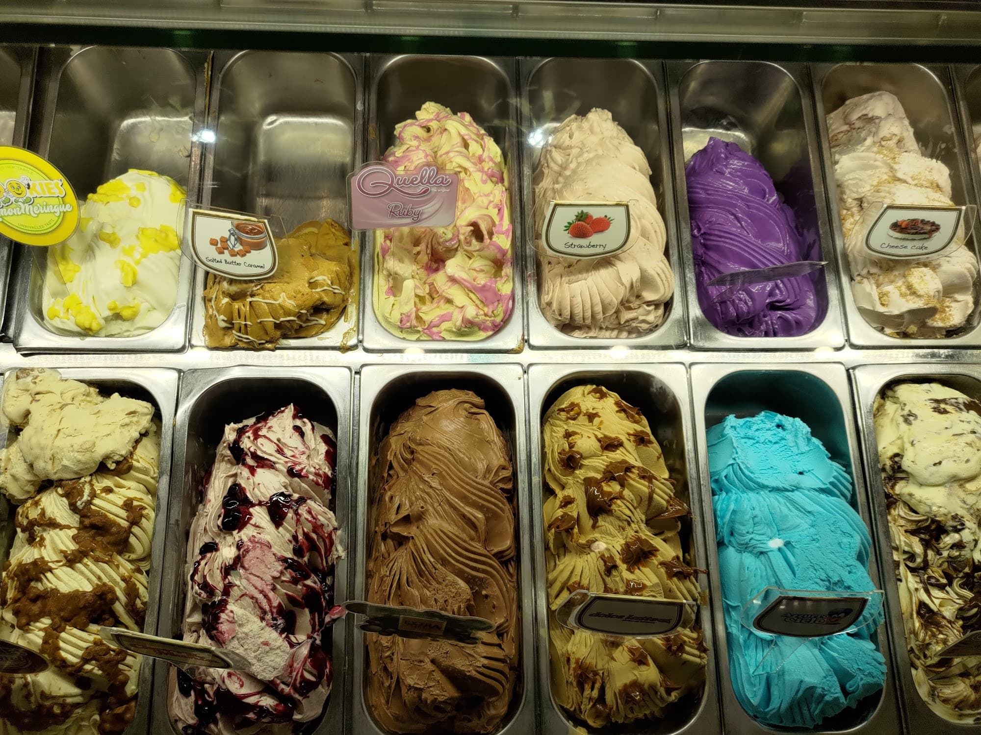 Close-up view of the gelato display case showing multiple artisan flavors
