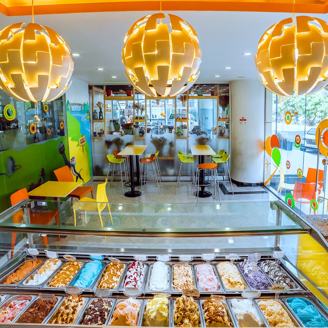Interior perspective of Tutto Gelato shop with decorative sphere pendant lighting