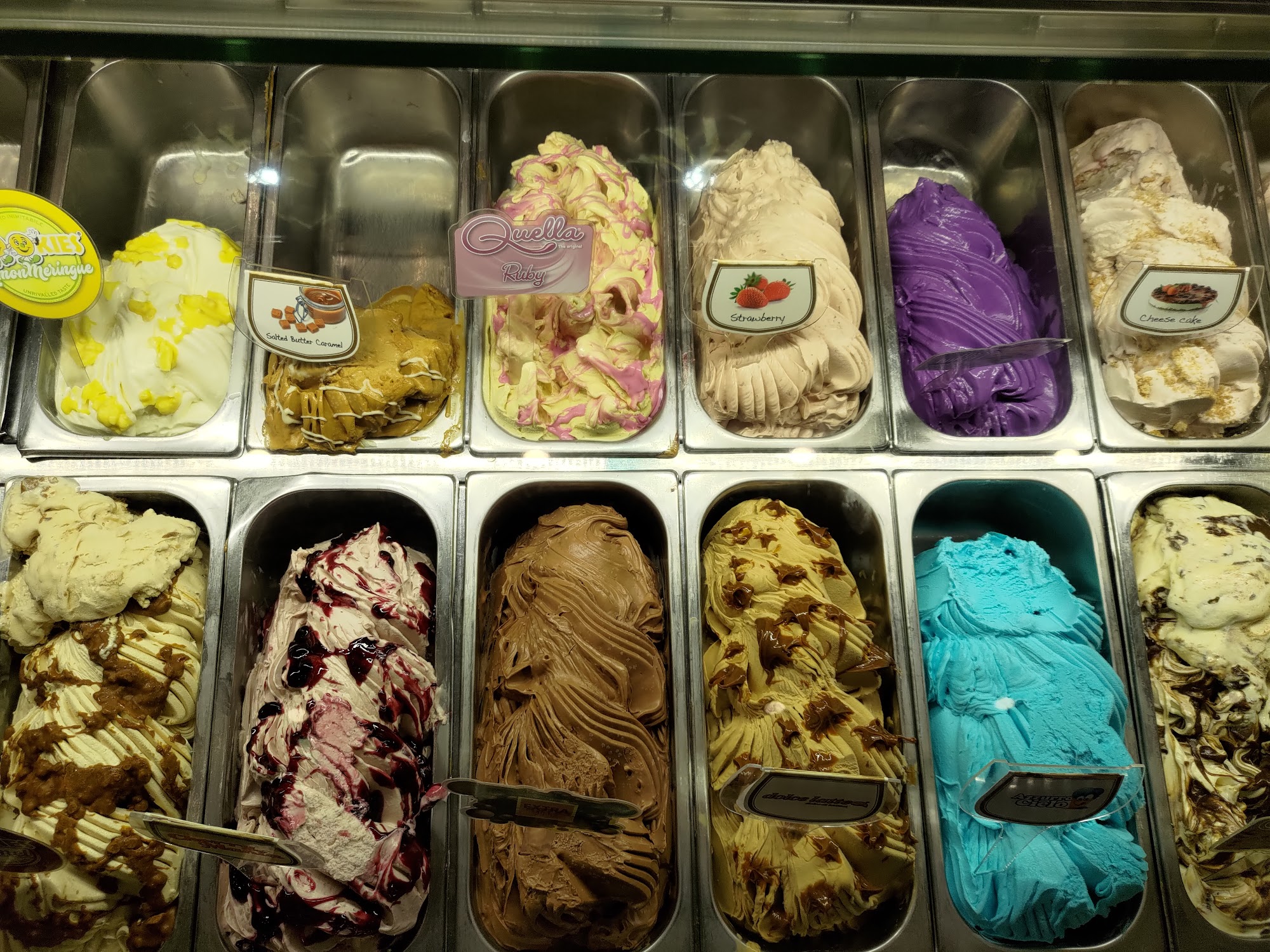 Close-up view of the gelato display case showing multiple artisan flavors